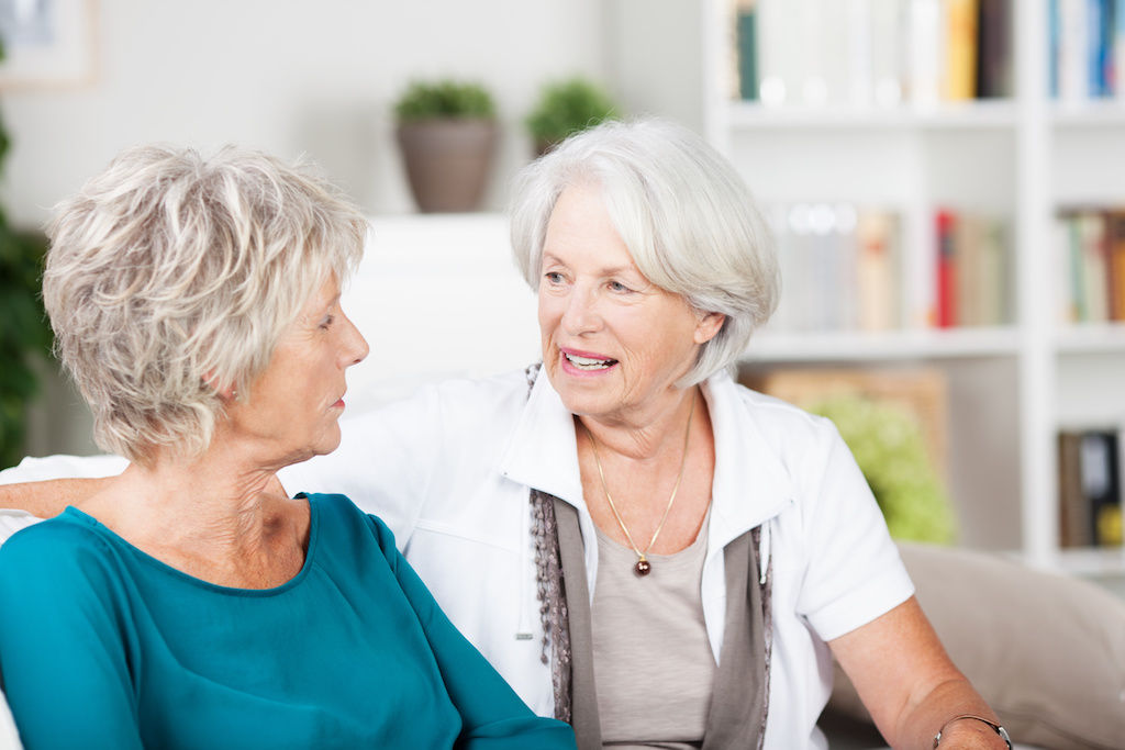 Two senior women roommates having a conversation